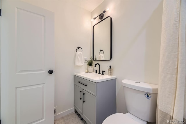 full bath with vanity, baseboards, and toilet