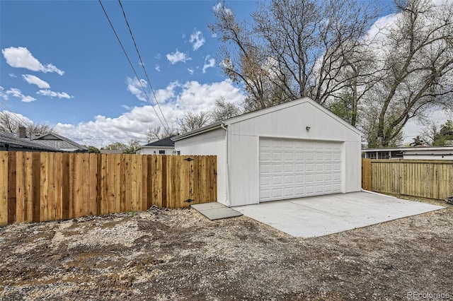 detached garage featuring fence