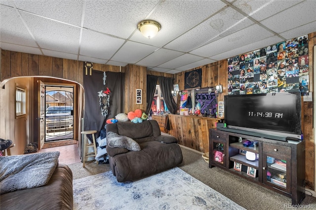 1437 Cypress St, Pueblo, CO 81004 - carpeted living room with wooden walls and a paneled ceiling