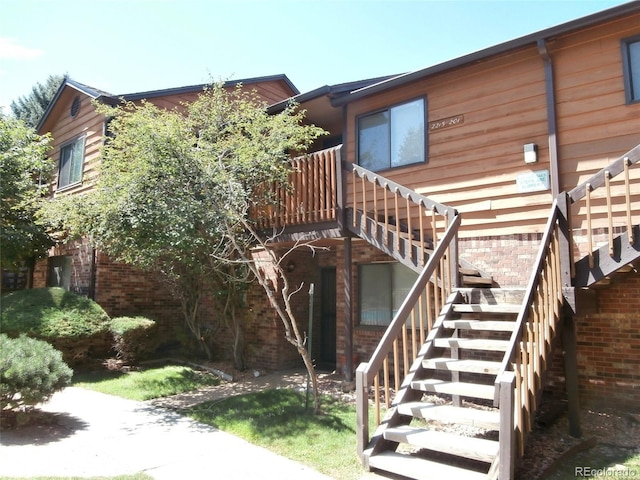 2215 S Buckley Rd Unit 201, Aurora, CO 80013 - rear view of house with stairway, a deck, and brick siding