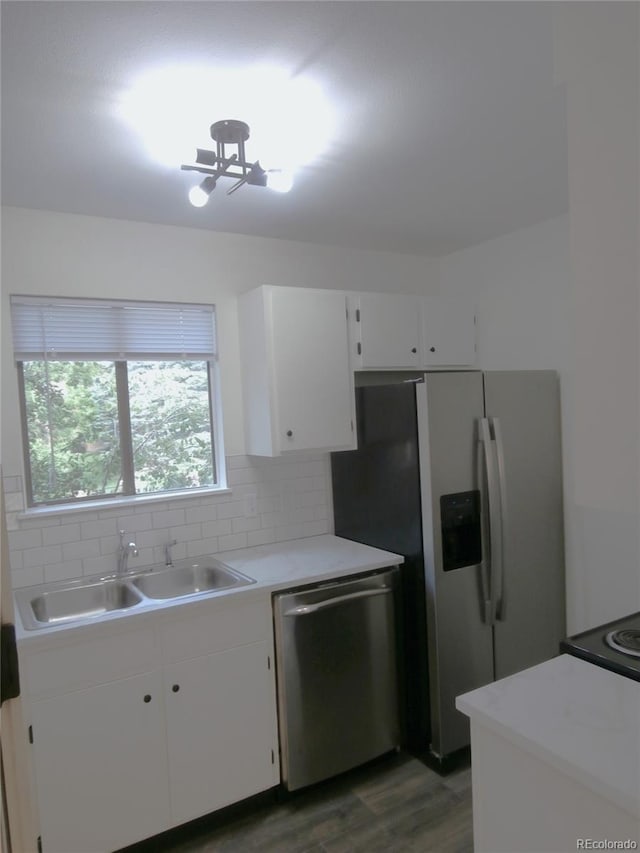 2215 S Buckley Rd Unit 201, Aurora, CO 80013 - kitchen with stainless steel appliances, a sink, wood finished floors, light countertops, and white cabinetry