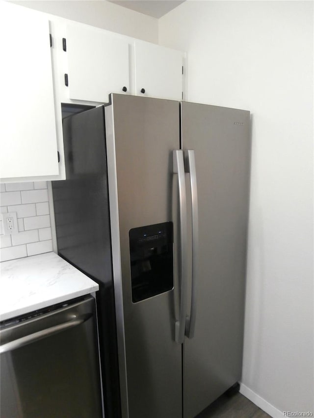 2215 S Buckley Rd Unit 201, Aurora, CO 80013 - kitchen with appliances with stainless steel finishes, backsplash, and white cabinets