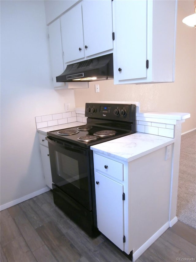 2215 S Buckley Rd Unit 201, Aurora, CO 80013 - kitchen with black range with electric cooktop, under cabinet range hood, white cabinetry, and dark wood-style flooring