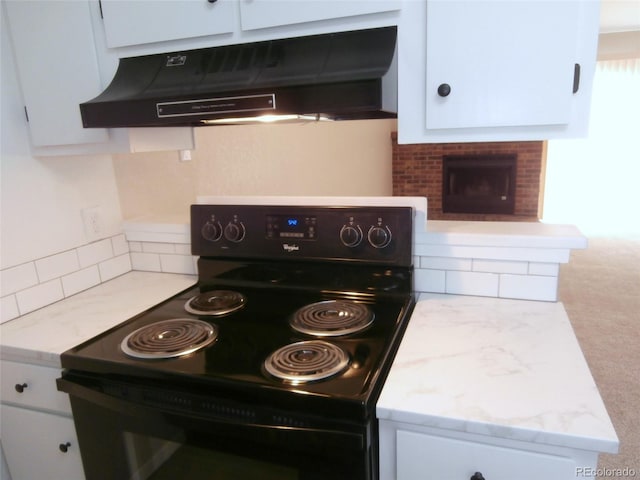 2215 S Buckley Rd Unit 201, Aurora, CO 80013 - kitchen with black / electric stove, under cabinet range hood, decorative backsplash, and white cabinetry