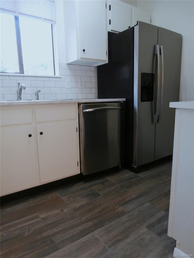 2215 S Buckley Rd Unit 201, Aurora, CO 80013 - kitchen featuring appliances with stainless steel finishes, white cabinets, light countertops, and backsplash