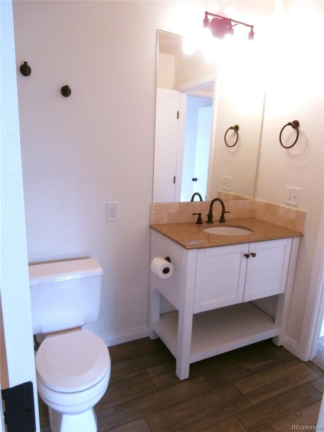 2215 S Buckley Rd Unit 201, Aurora, CO 80013 - half bath with wood finished floors, vanity, toilet, and baseboards