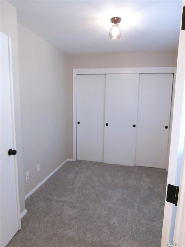 2215 S Buckley Rd Unit 201, Aurora, CO 80013 - unfurnished bedroom featuring carpet flooring and a closet