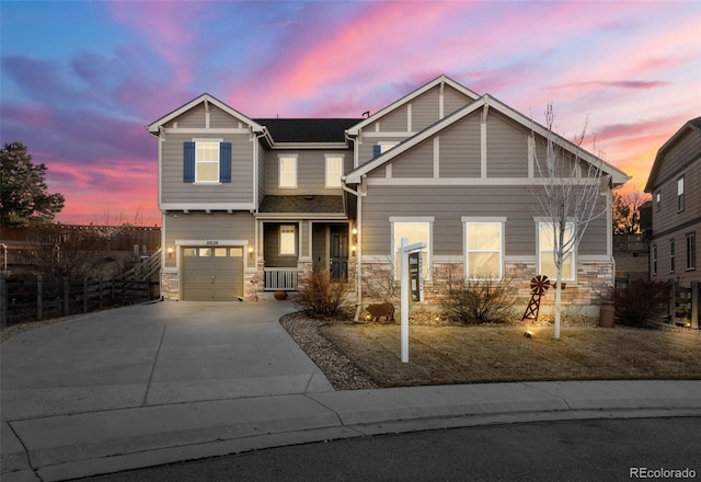 craftsman-style house featuring stone siding, a porch, concrete driveway, and a garage