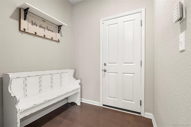 interior space with dark wood-type flooring and baseboards