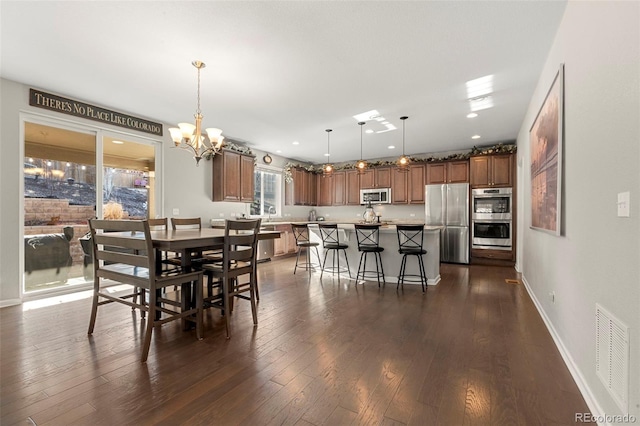 dining space with visible vents, a notable chandelier, dark wood finished floors, recessed lighting, and baseboards