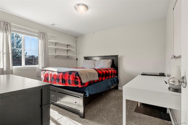 carpeted bedroom with visible vents and baseboards