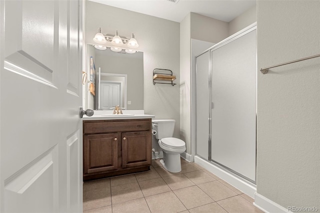 full bath with vanity, tile patterned floors, toilet, and a stall shower