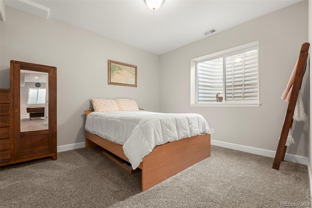 bedroom featuring visible vents, baseboards, and carpet