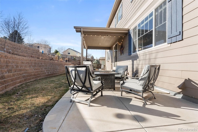 view of patio / terrace with an outdoor fire pit and fence