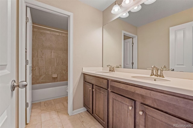 full bath featuring double vanity, washtub / shower combination, baseboards, and a sink