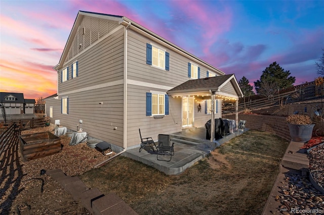 21028 E Saratoga Ave, Aurora, CO 80015 - back of property at dusk with a patio and a garden
