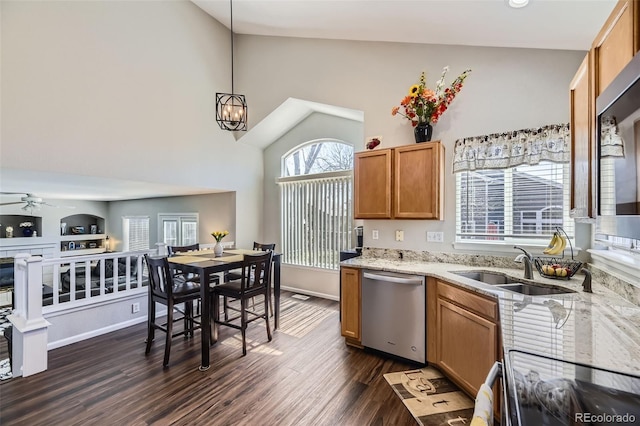4708 Rock Pipit Ct, Highlands Ranch, CO 80126 - kitchen featuring stainless steel dishwasher, a sink, a ceiling fan, high vaulted ceiling, and light stone counters
