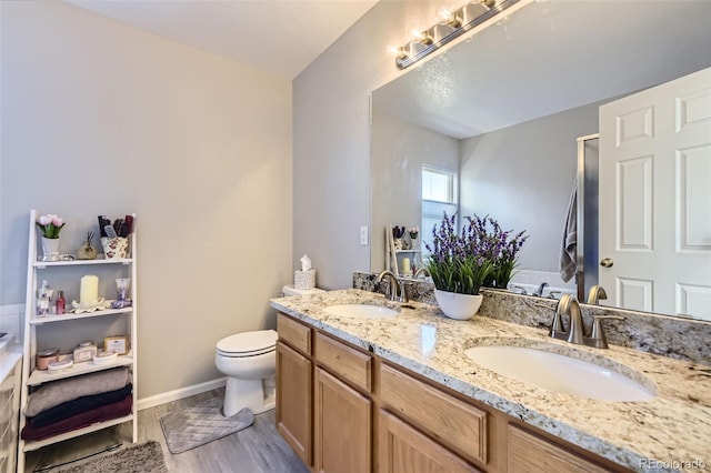 4708 Rock Pipit Ct, Highlands Ranch, CO 80126 - full bath featuring double vanity, toilet, wood finished floors, and baseboards
