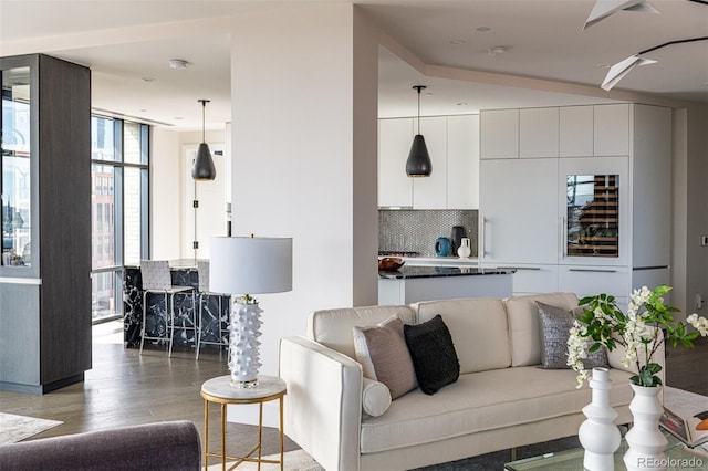 living area featuring a wall of windows and light wood-type flooring