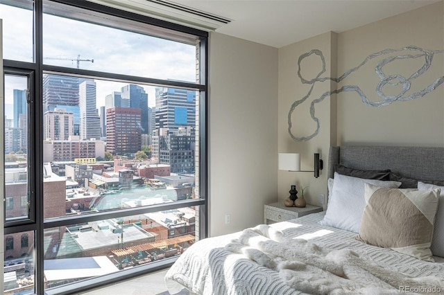 bedroom featuring expansive windows and a city view