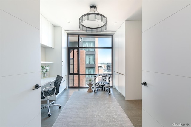 office area with a wall of windows and wood finished floors