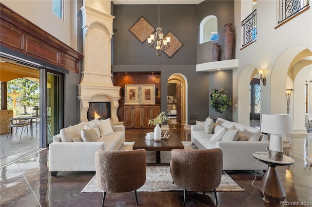 living area with arched walkways, a high ceiling, and a healthy amount of sunlight