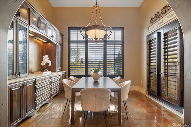 dining area with baseboards and tile patterned floors