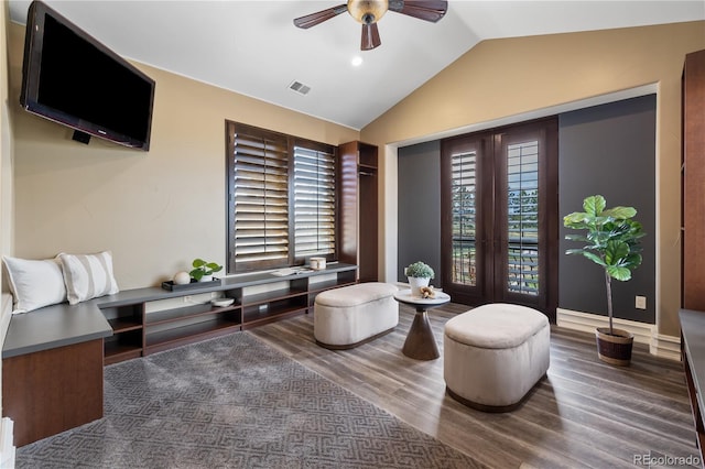 sitting room with wood finished floors, ceiling fan, lofted ceiling, and visible vents