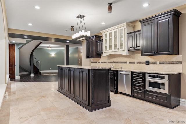 kitchen with arched walkways, decorative backsplash, stainless steel appliances, and recessed lighting