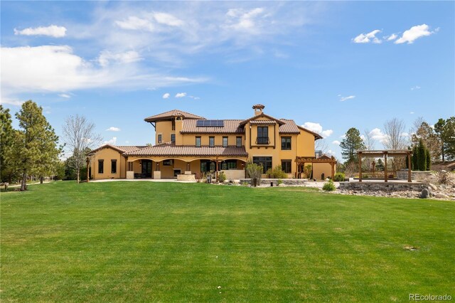 8417 High Ridge Ct, Castle Pines, CO 80108 - rear view of house with a patio, a lawn, a pergola, and solar panels