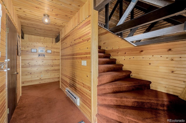 stairs featuring wooden ceiling, wood walls, carpet floors, and lofted ceiling