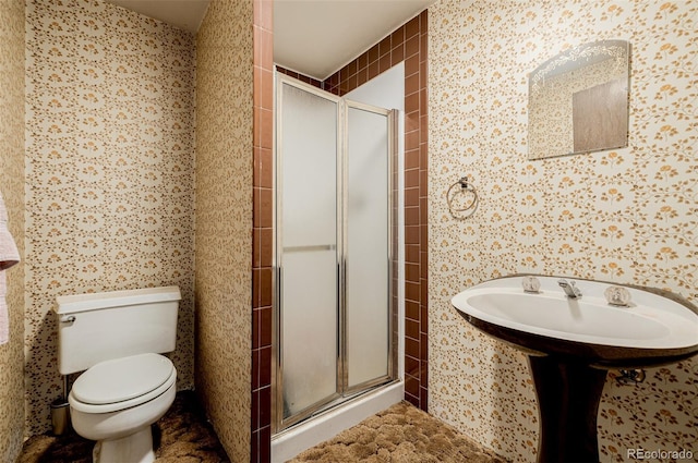 bathroom featuring a shower stall and toilet