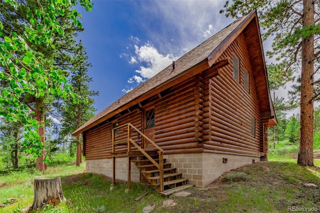 rear view of house featuring crawl space and log exterior
