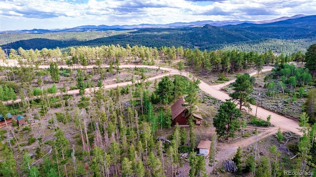 bird's eye view featuring a forest view and a mountain view