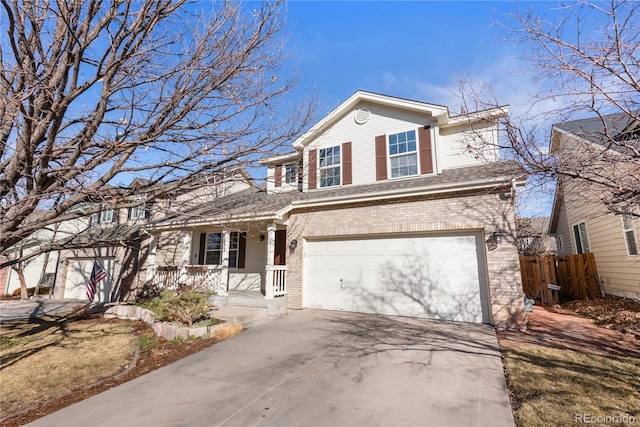 traditional-style house with an attached garage, covered porch, brick siding, fence, and concrete driveway