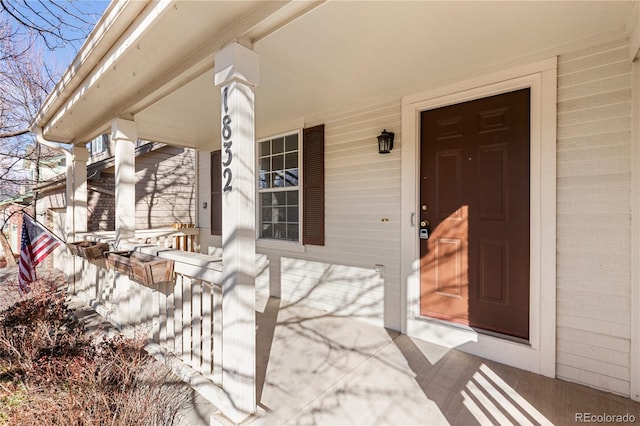 view of exterior entry featuring a porch