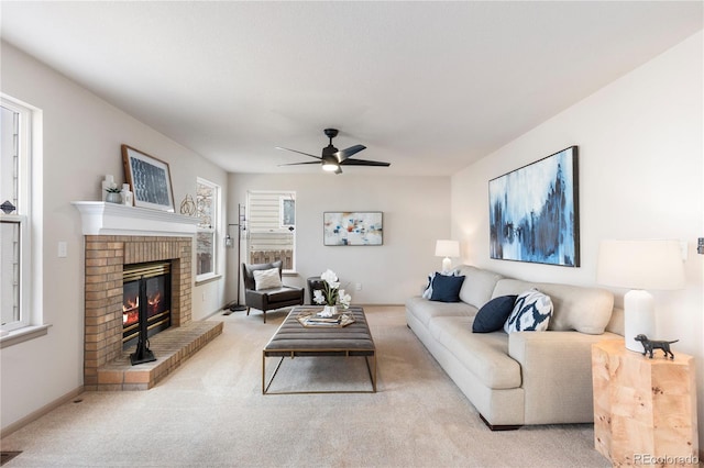 living room with visible vents, baseboards, a ceiling fan, light colored carpet, and a fireplace