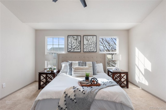 bedroom featuring light carpet and baseboards