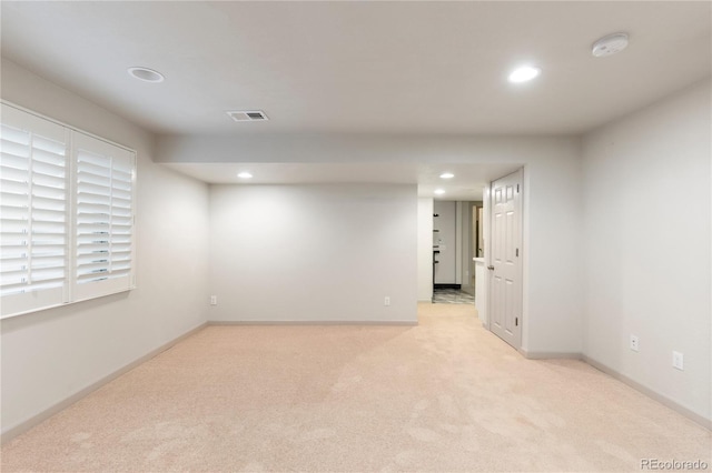 spare room featuring light carpet, baseboards, visible vents, and recessed lighting