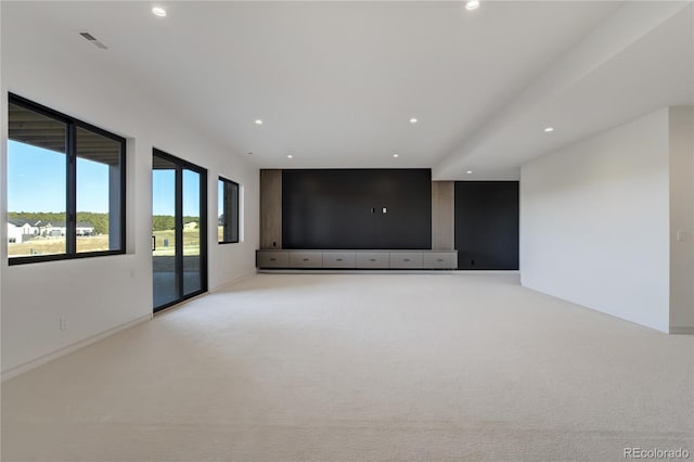 spare room with recessed lighting, light colored carpet, and visible vents