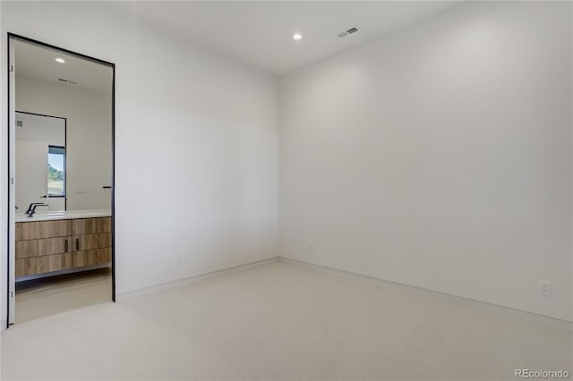 empty room with light colored carpet, recessed lighting, and visible vents