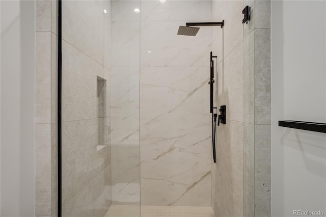 bathroom with a marble finish shower