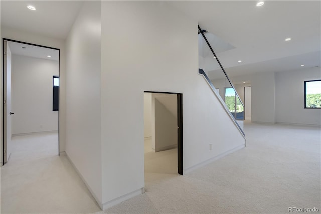 hall with baseboards, carpet flooring, and recessed lighting