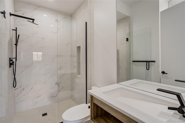 full bathroom featuring vanity, a marble finish shower, and toilet