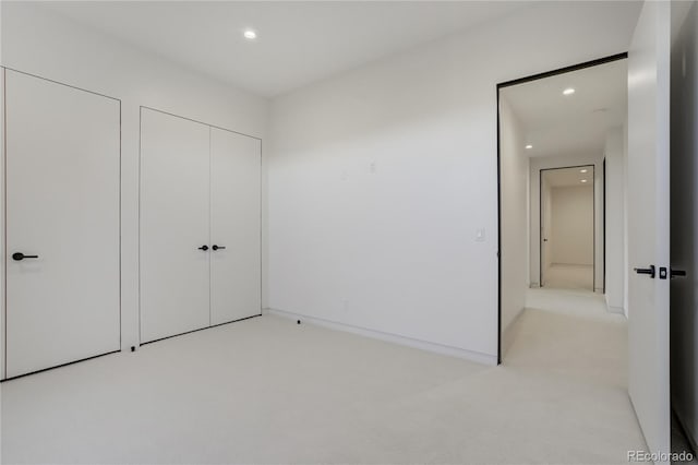 unfurnished bedroom featuring light carpet and recessed lighting