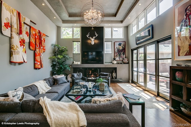 460 N Garfield St, Denver, CO 80206 - living area featuring wood finished floors, a chandelier, a raised ceiling, and a towering ceiling