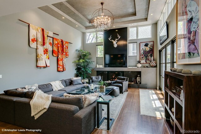 460 N Garfield St, Denver, CO 80206 - living area featuring a raised ceiling, a high ceiling, a chandelier, and wood finished floors
