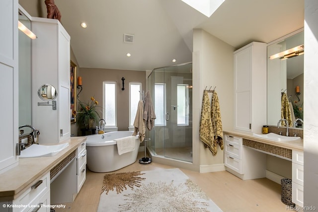 460 N Garfield St, Denver, CO 80206 - bathroom featuring a stall shower, a soaking tub, vanity, recessed lighting, and a skylight