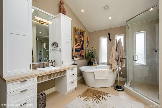 460 N Garfield St, Denver, CO 80206 - bathroom with a shower stall, vaulted ceiling, a soaking tub, vanity, and recessed lighting