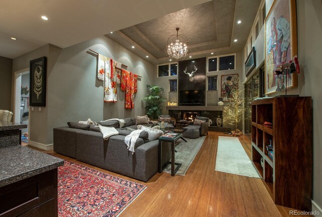 460 N Garfield St, Denver, CO 80206 - living room featuring a raised ceiling, wood finished floors, a chandelier, and recessed lighting